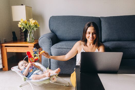 A mom working from home with a small baby nearby