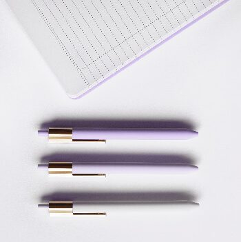 A table with a tablet and 3 pens