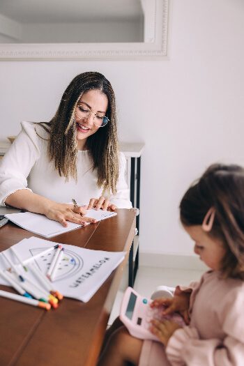 mom and daughter sitting at kitchen table